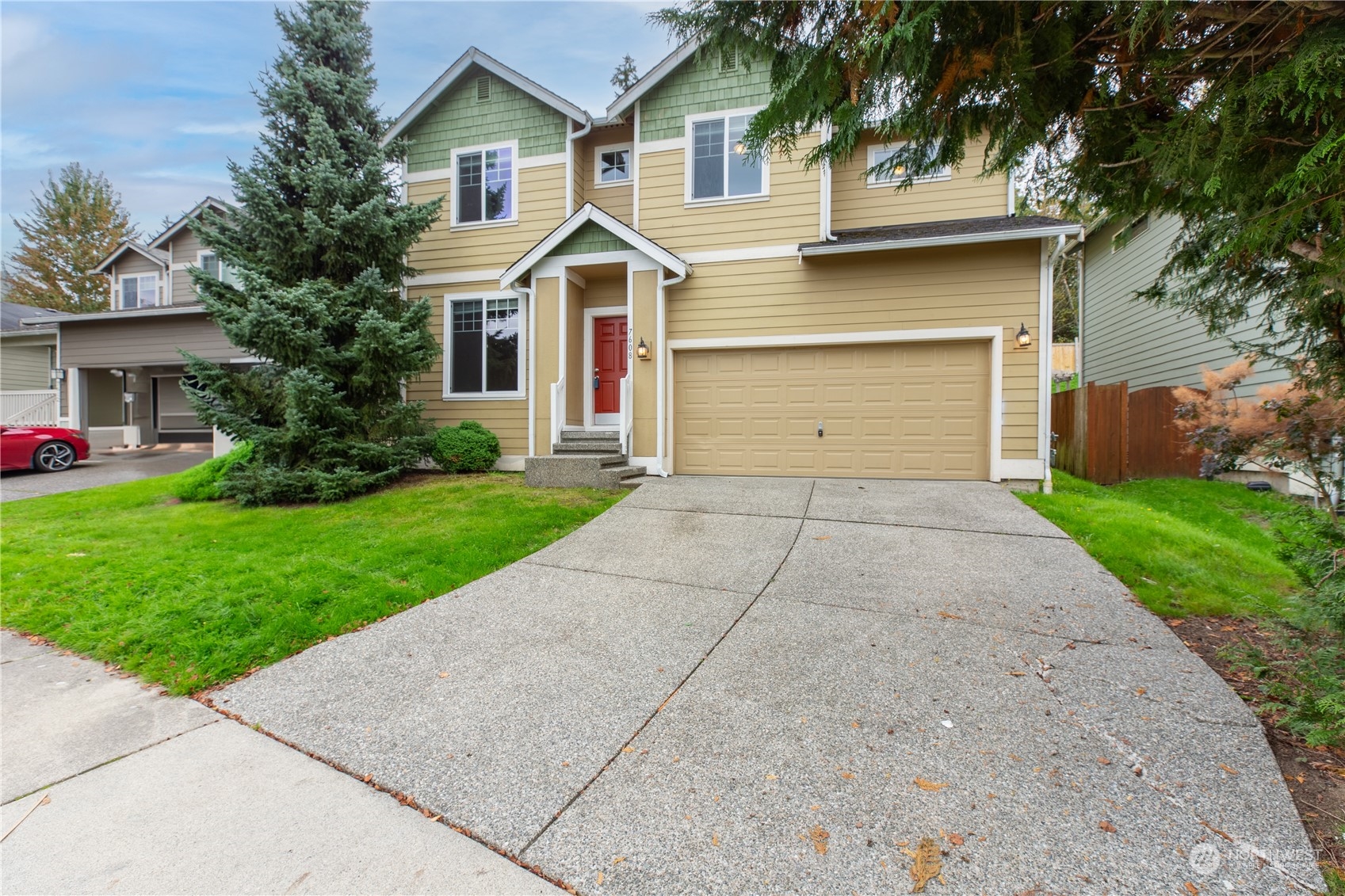 a front view of house with yard and green space