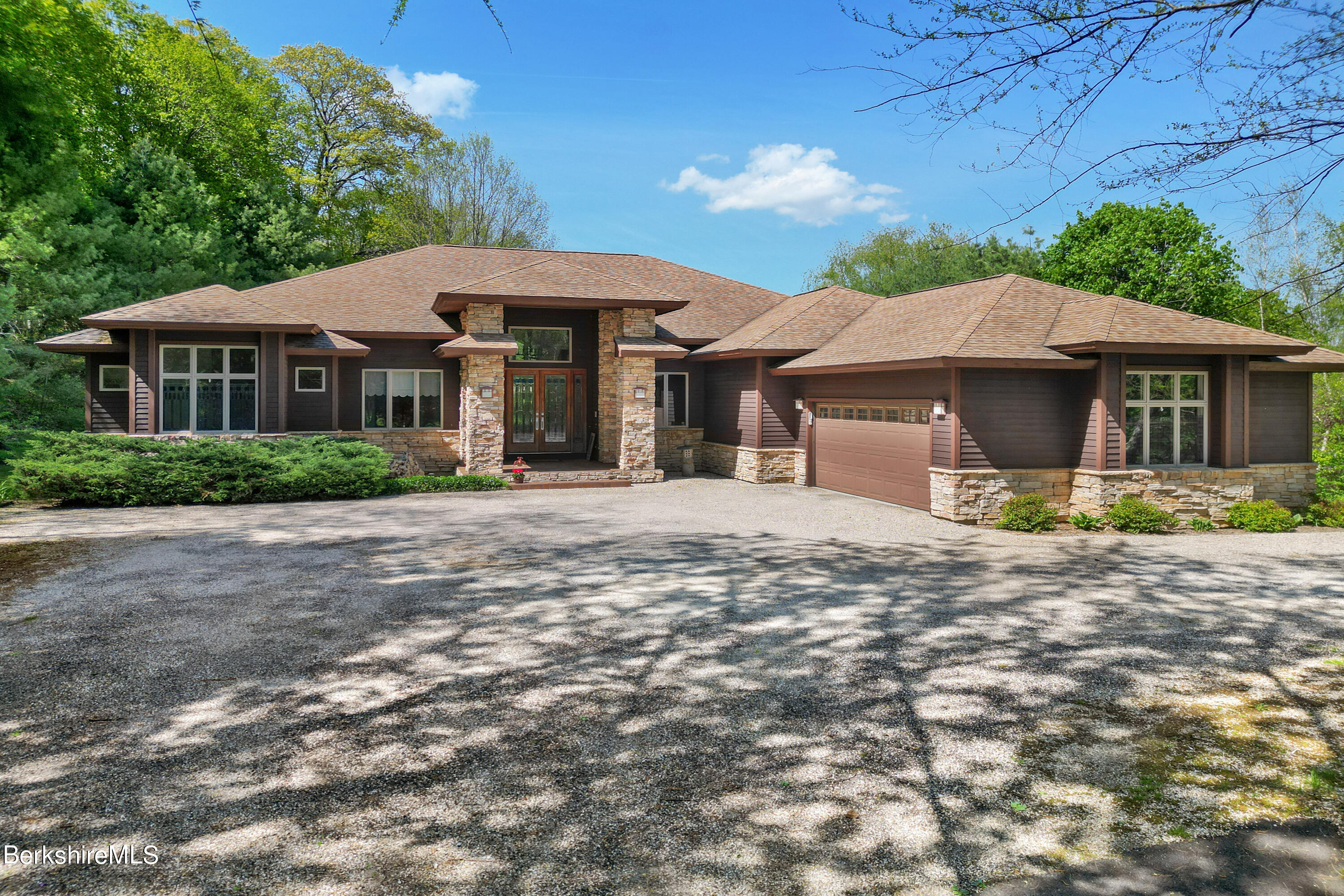 a front view of a house with a garden