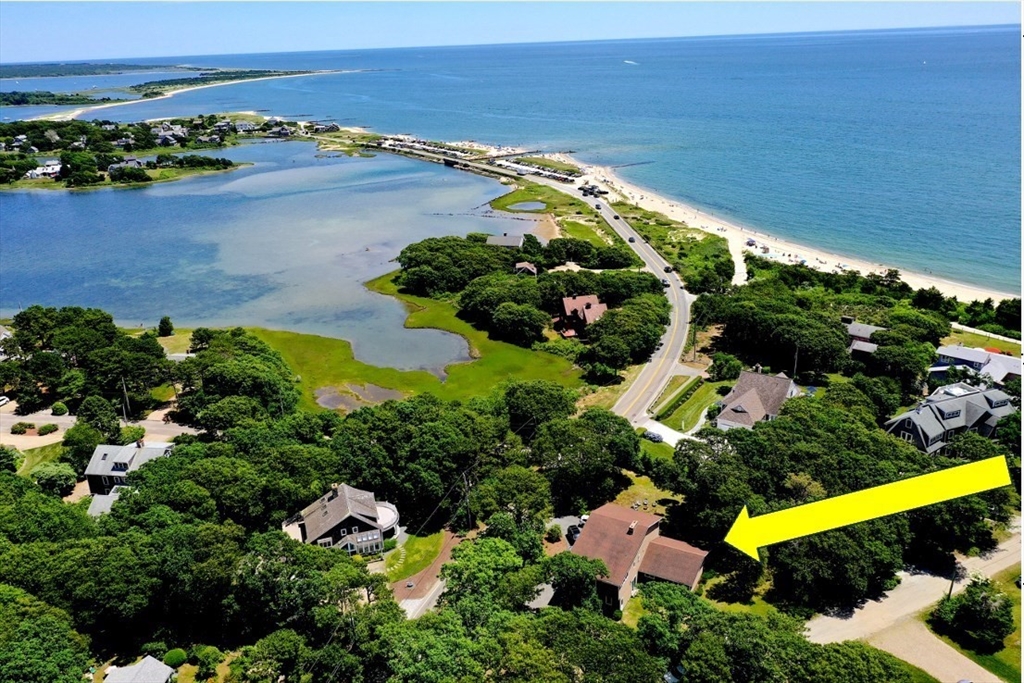 an aerial view of lake and residential houses with outdoor space