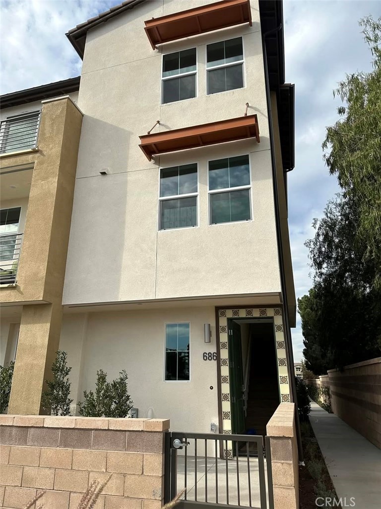 a front view of a house with plants