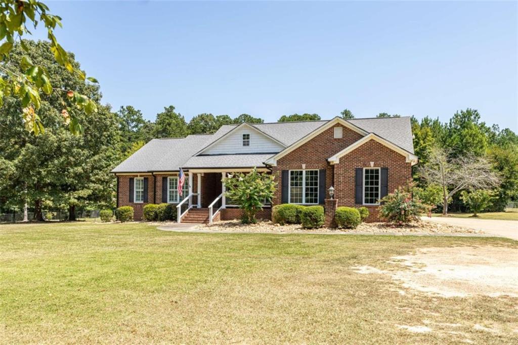 a front view of house with yard outdoor seating and barbeque oven