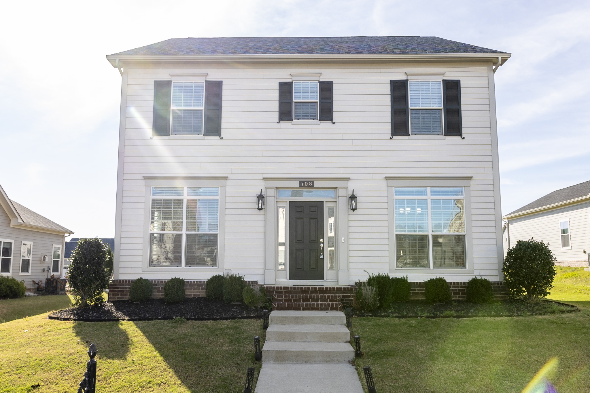 a front view of a house with garden