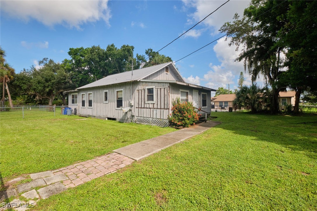 a front view of house with yard and green space