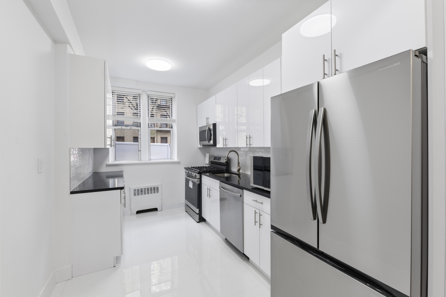 a kitchen with stainless steel appliances a refrigerator sink and stove