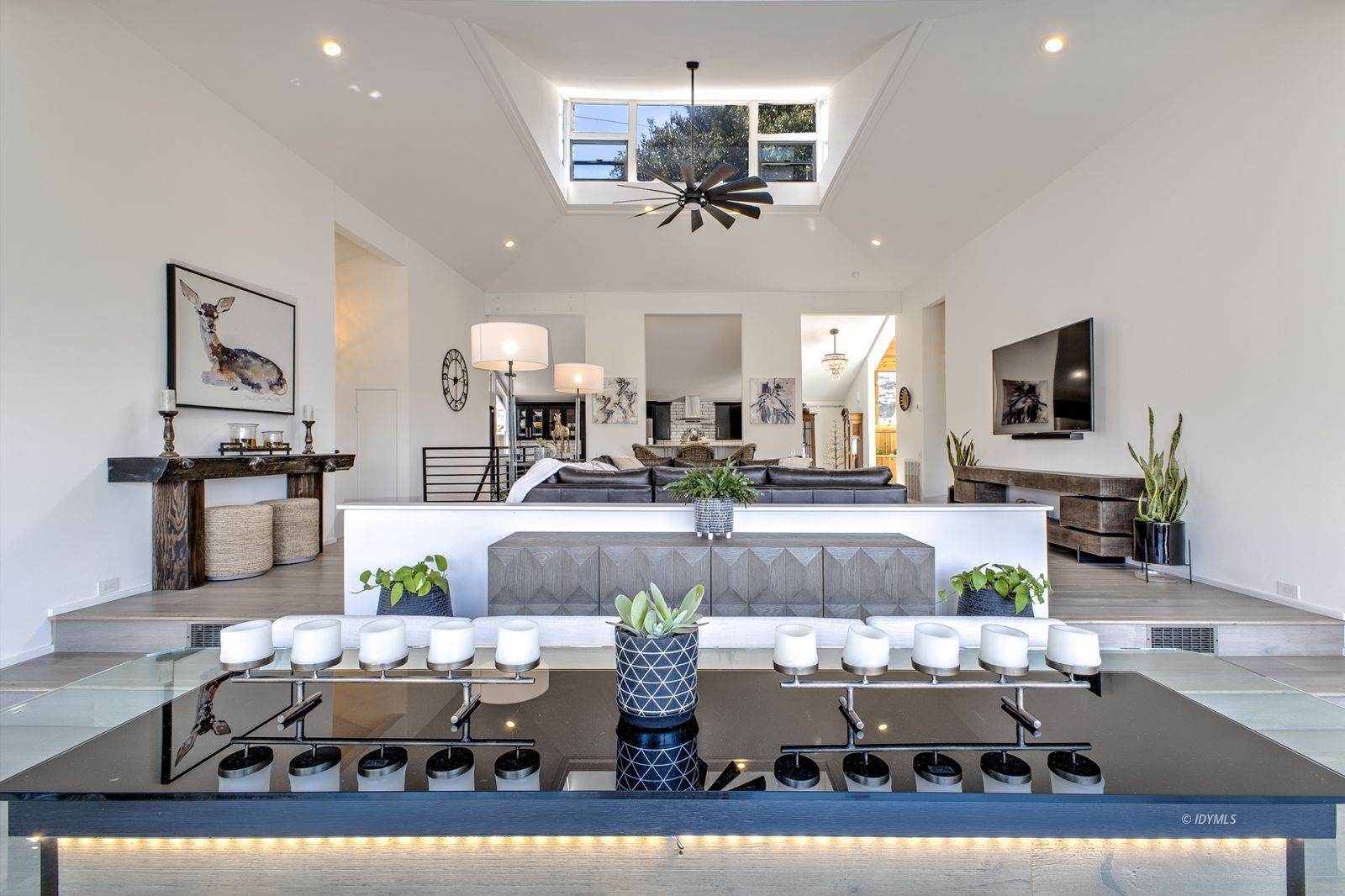 a living room with lots of furniture and kitchen view