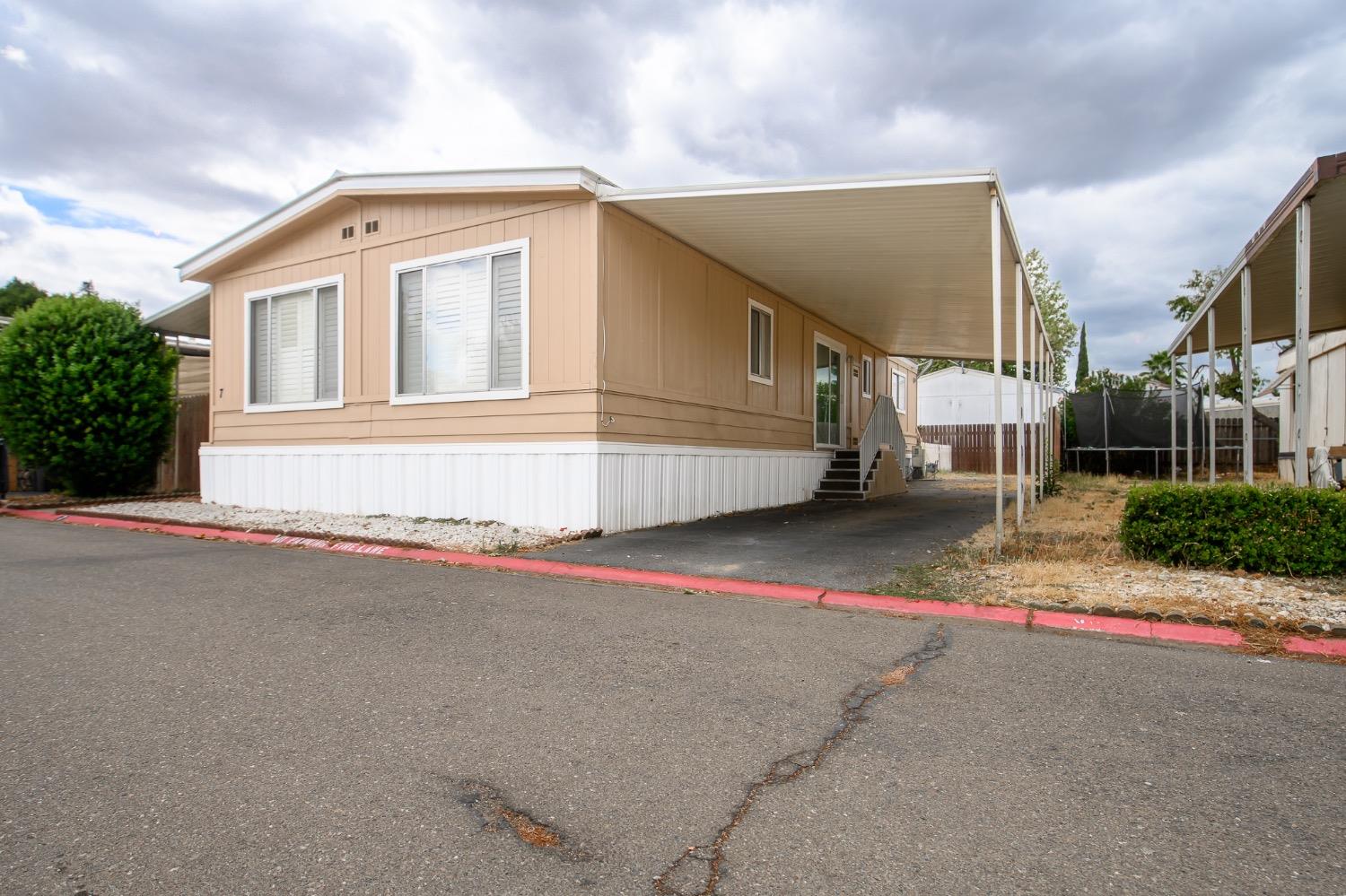 a front view of a house with a road