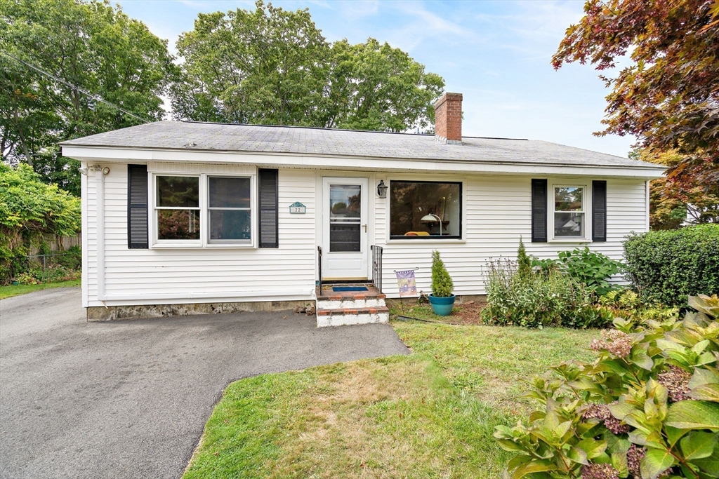 a view of a house with a small yard and plants