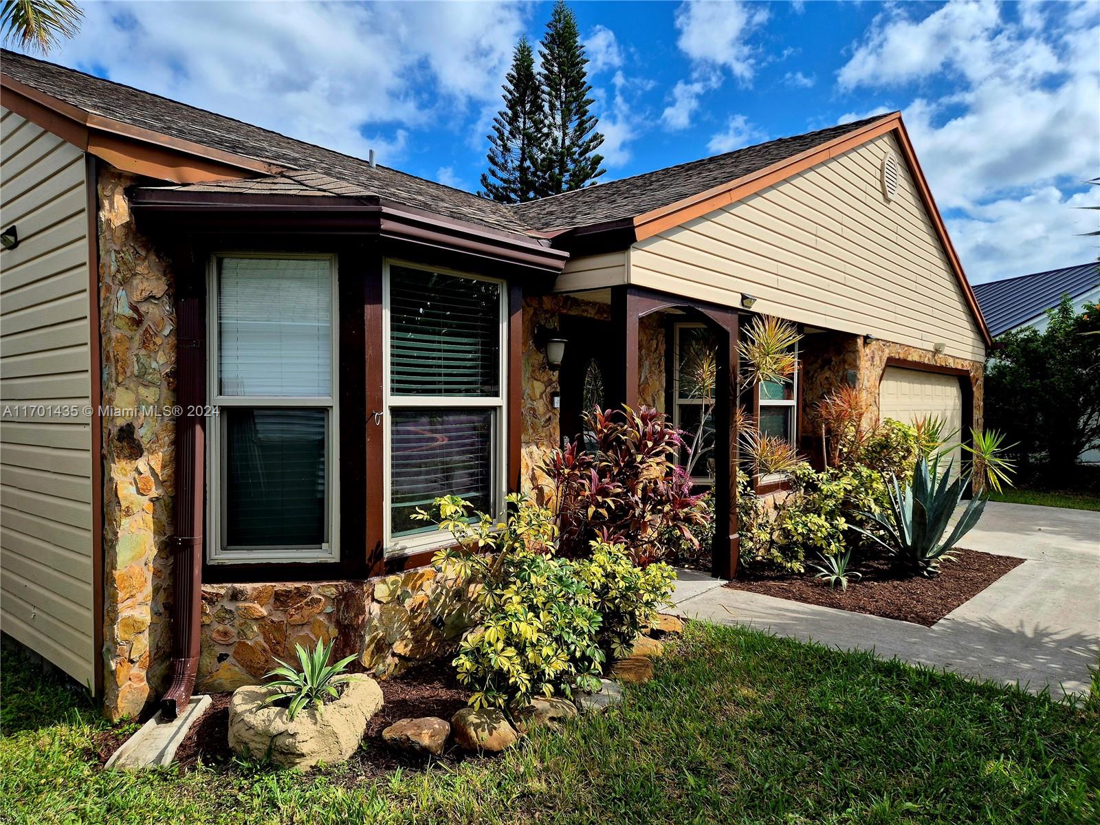 a front view of a house with garden