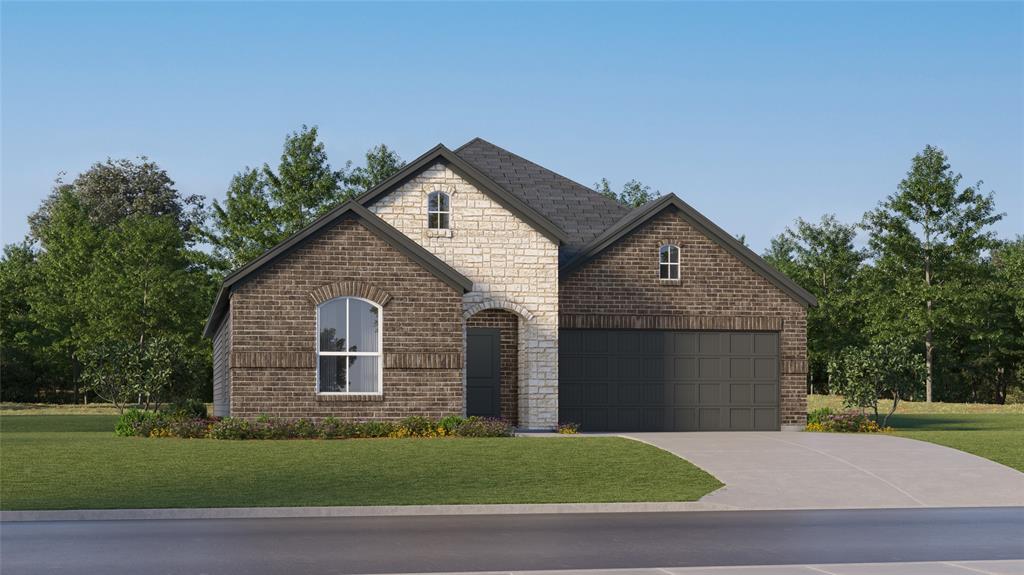 View of front of property featuring a garage and a front yard