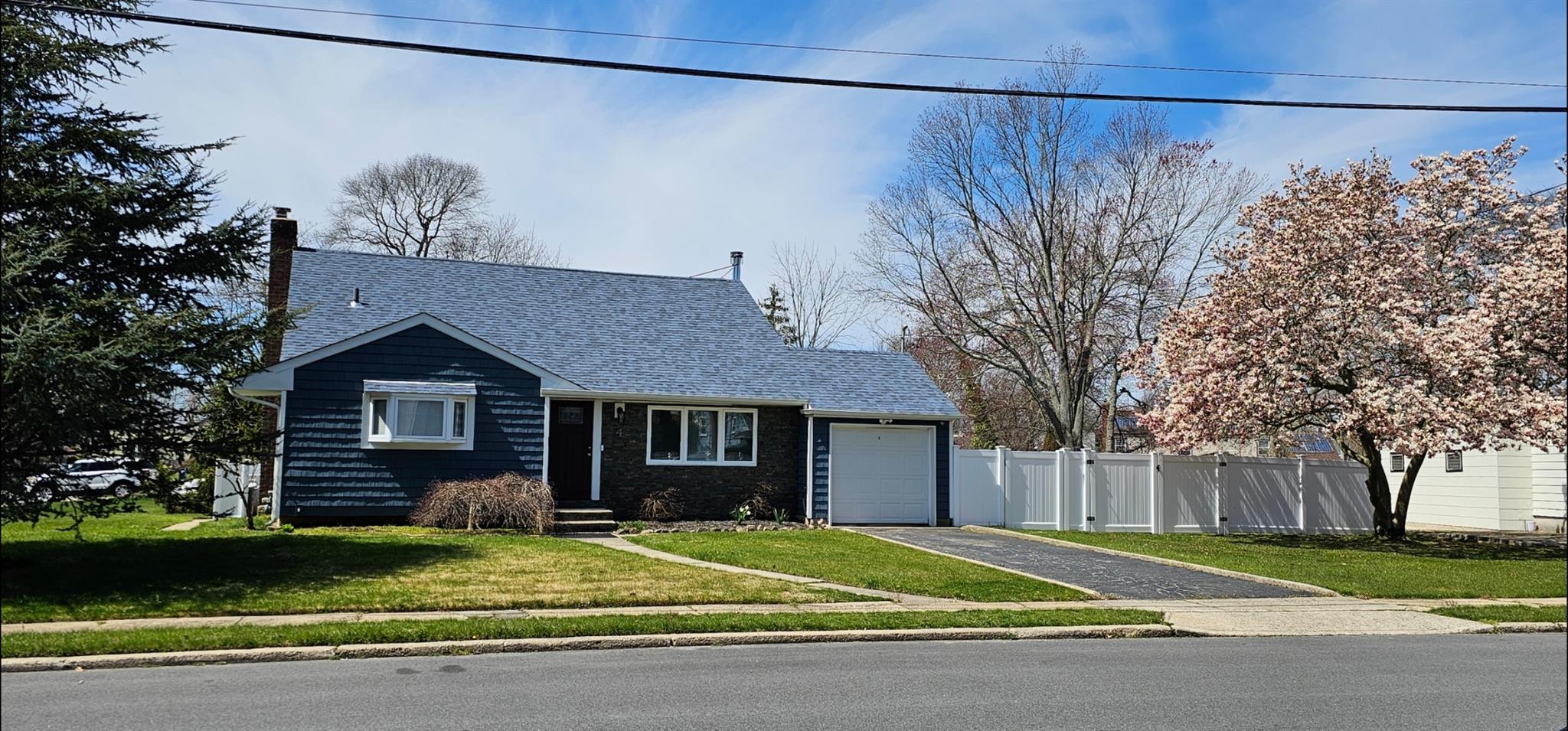 View of front of house with a garage and a front yard