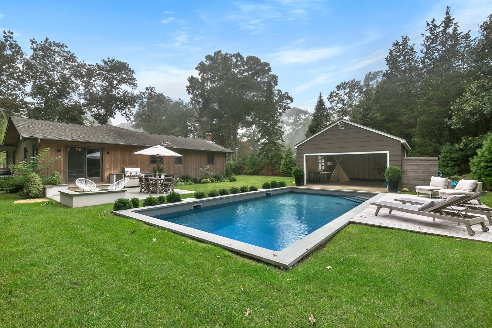 a front view of house with yard and outdoor seating