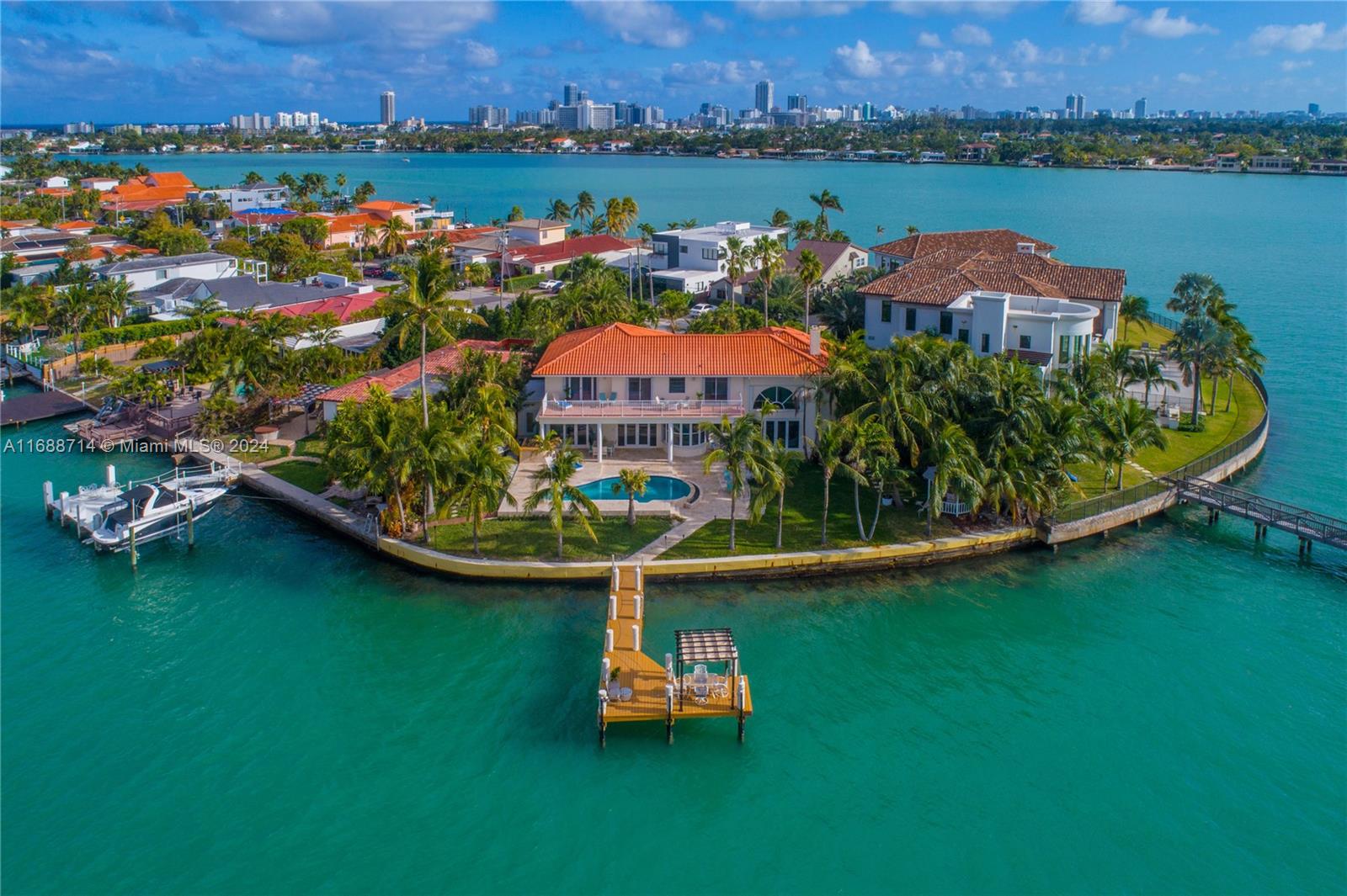 an aerial view of residential houses with outdoor space and lake view