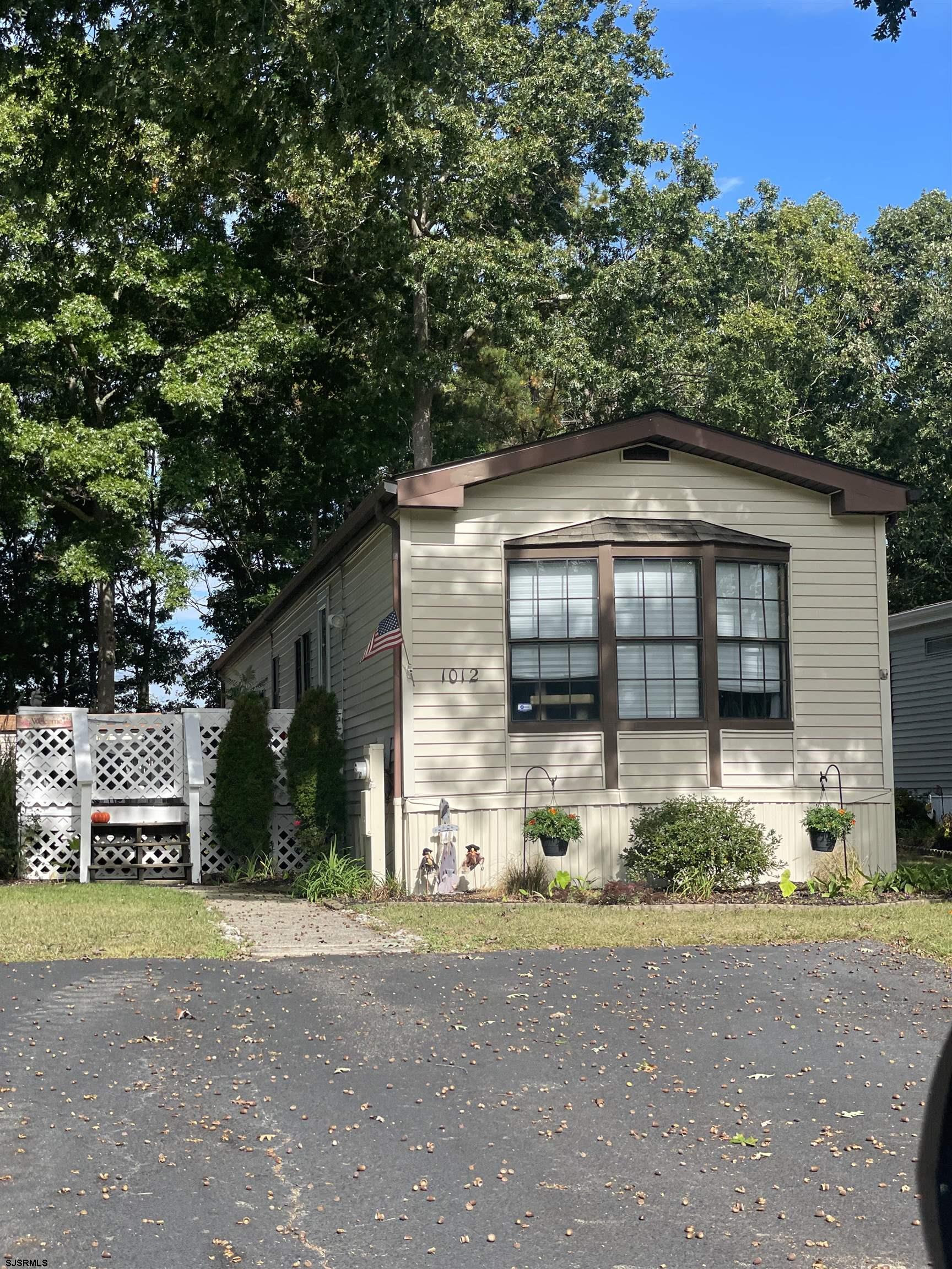 a front view of a house with a garden and plants