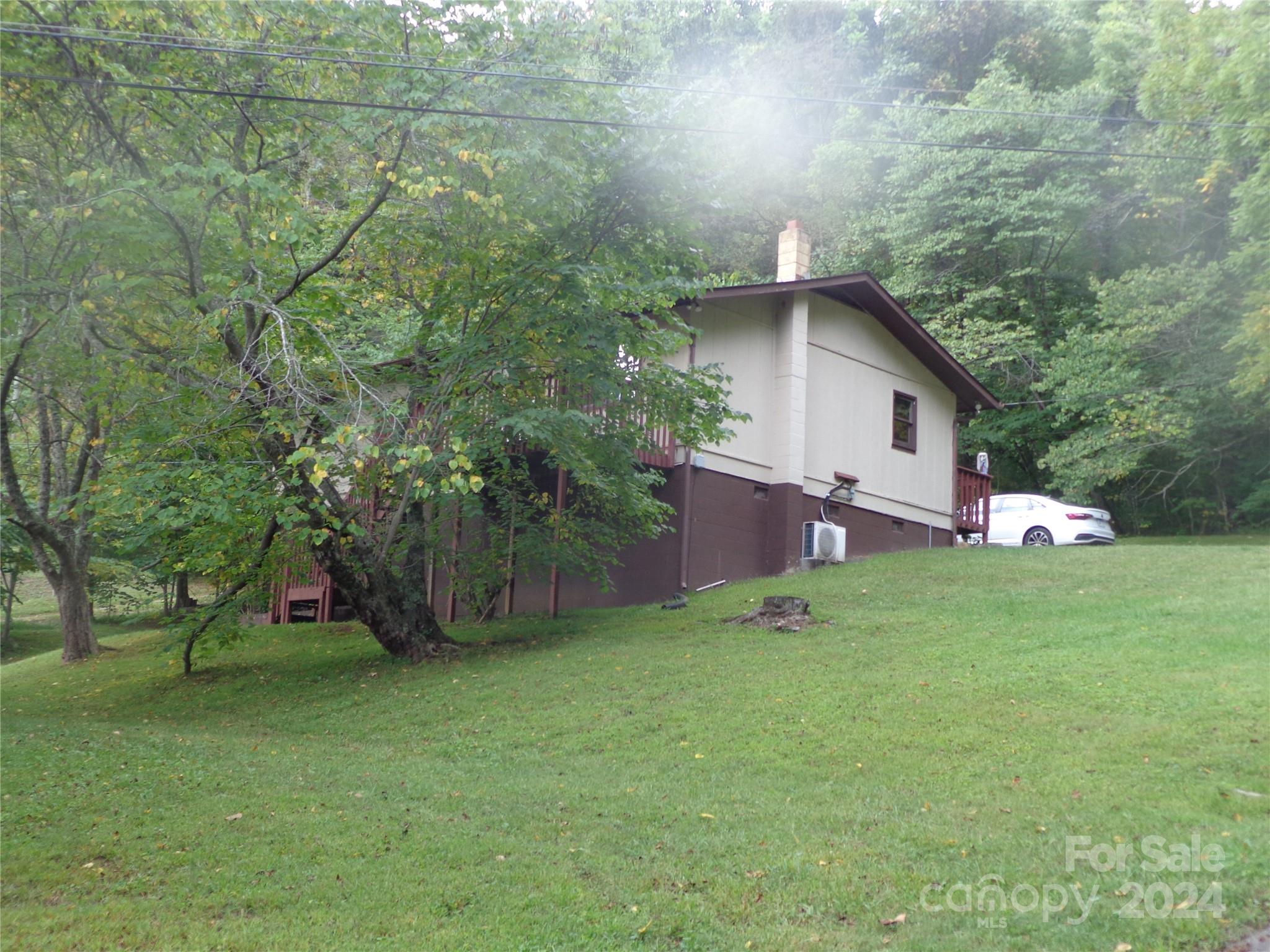 a view of backyard of house with green space