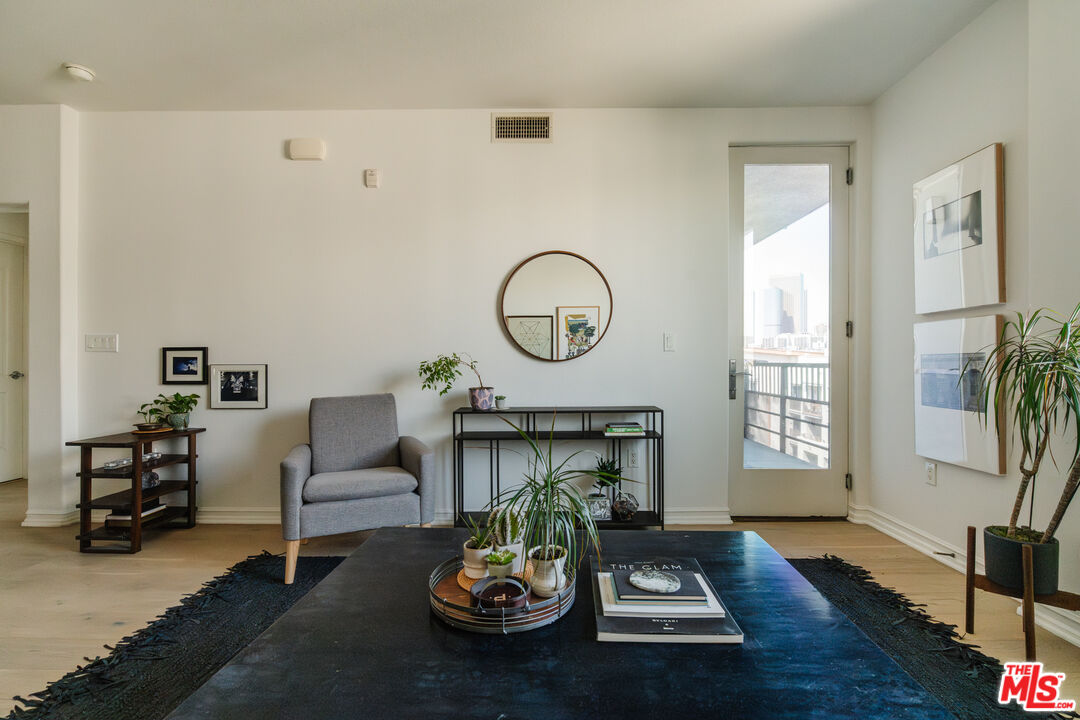 a living room with furniture a fireplace and wooden floor