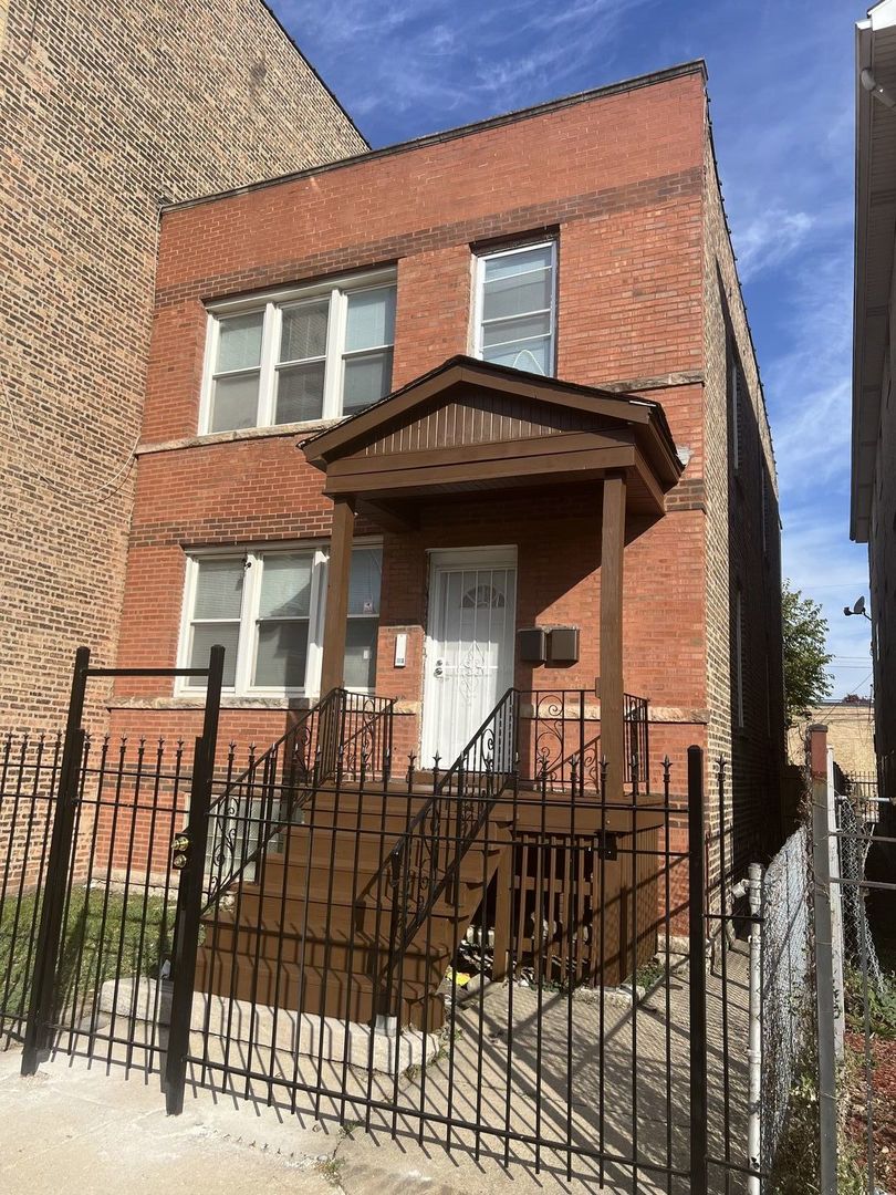 a view of a brick house with many windows