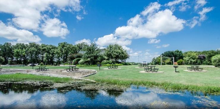 a view of outdoor space with green field and trees