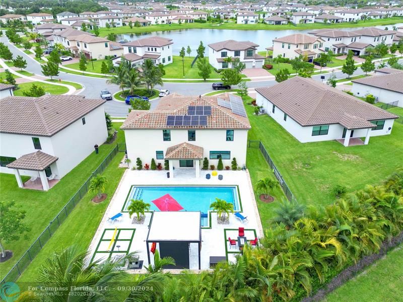 an aerial view of multiple houses with yard