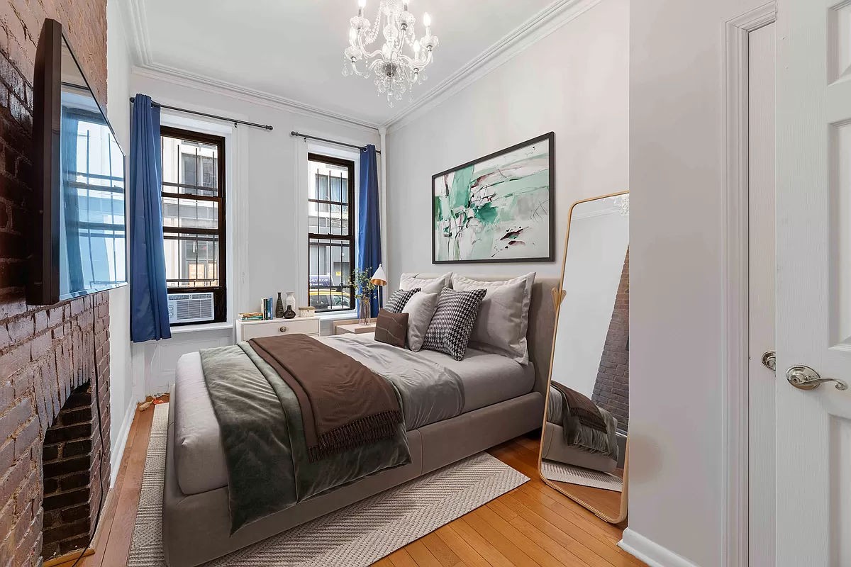 a bedroom with bed and a chandelier