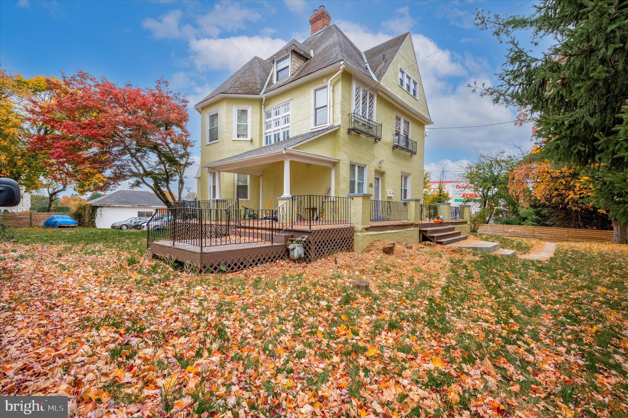 a view of a white house with a yard