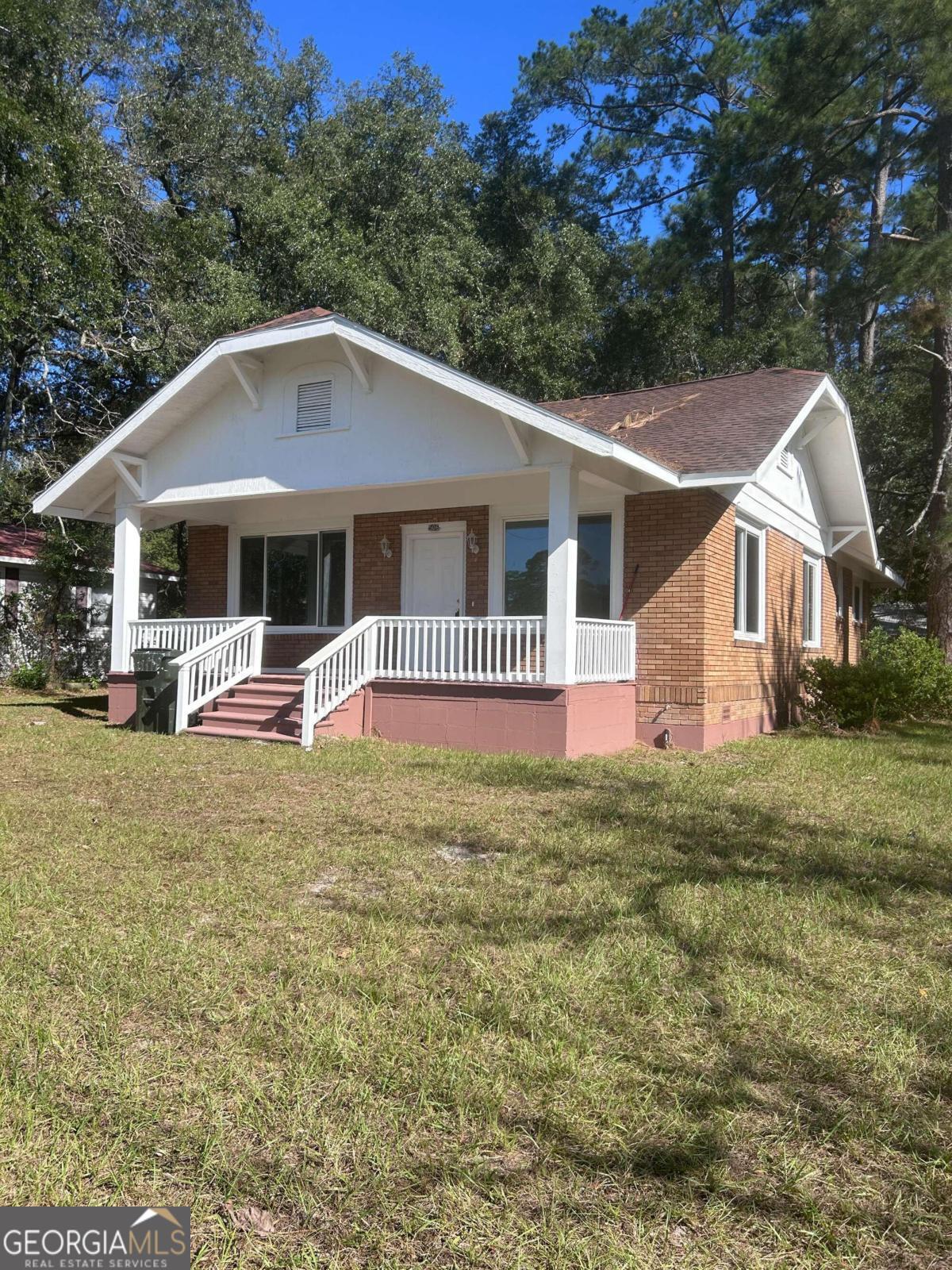 a front view of a house with garden