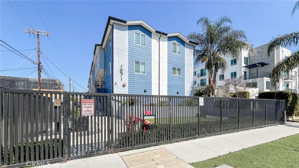 a view of a house with a wooden fence