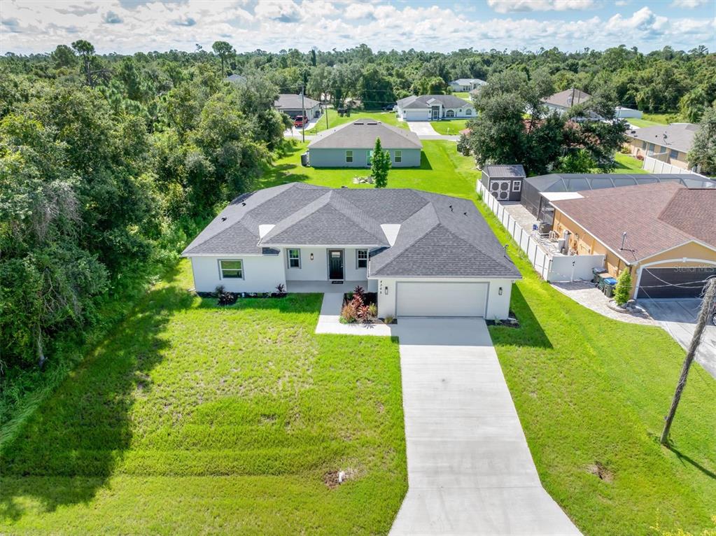 an aerial view of a house with swimming pool garden and mountain view