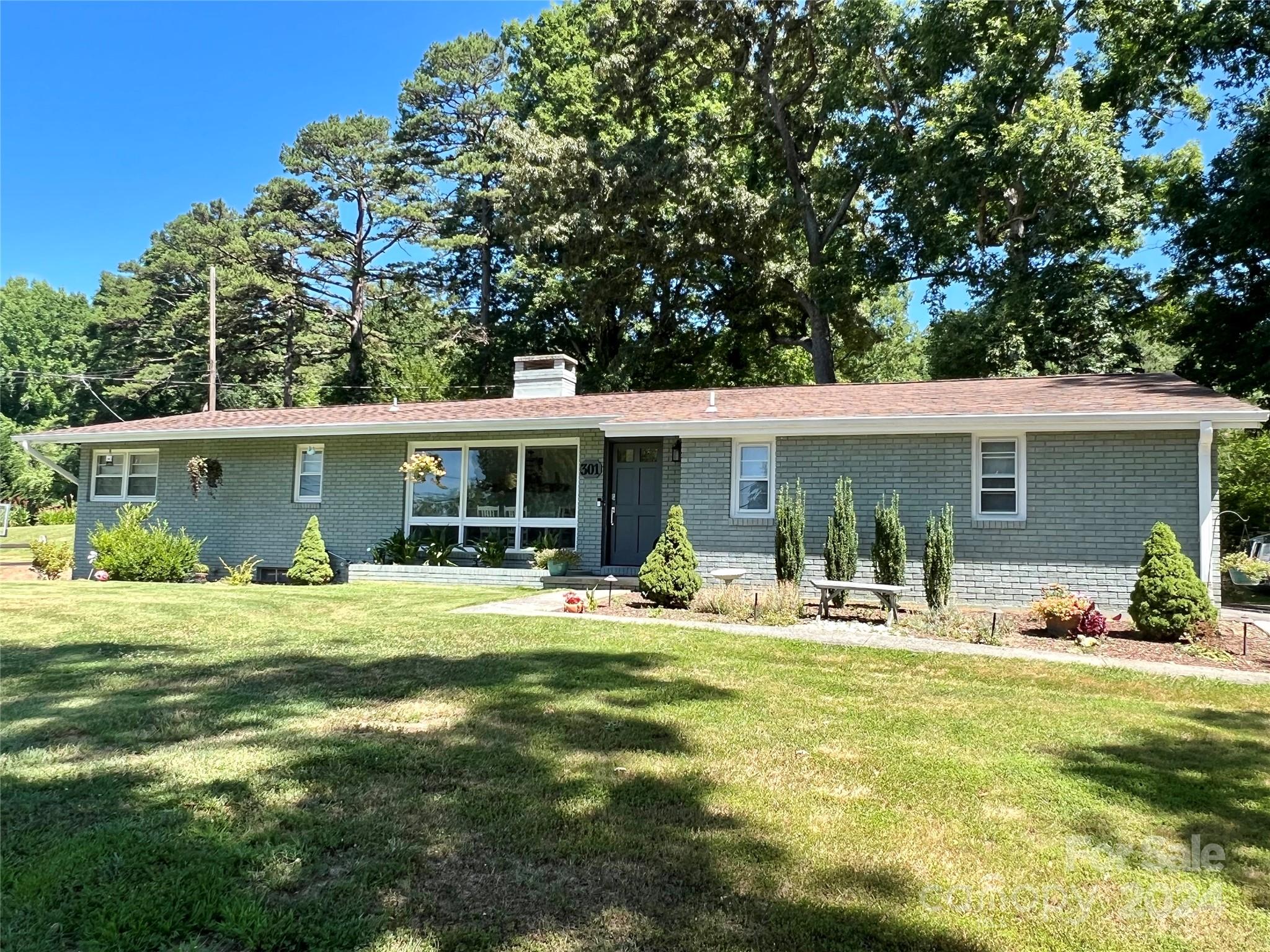 a front view of house with outdoor seating and yard