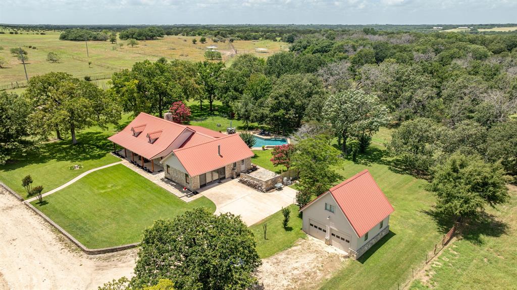 an aerial view of a house with a lake view