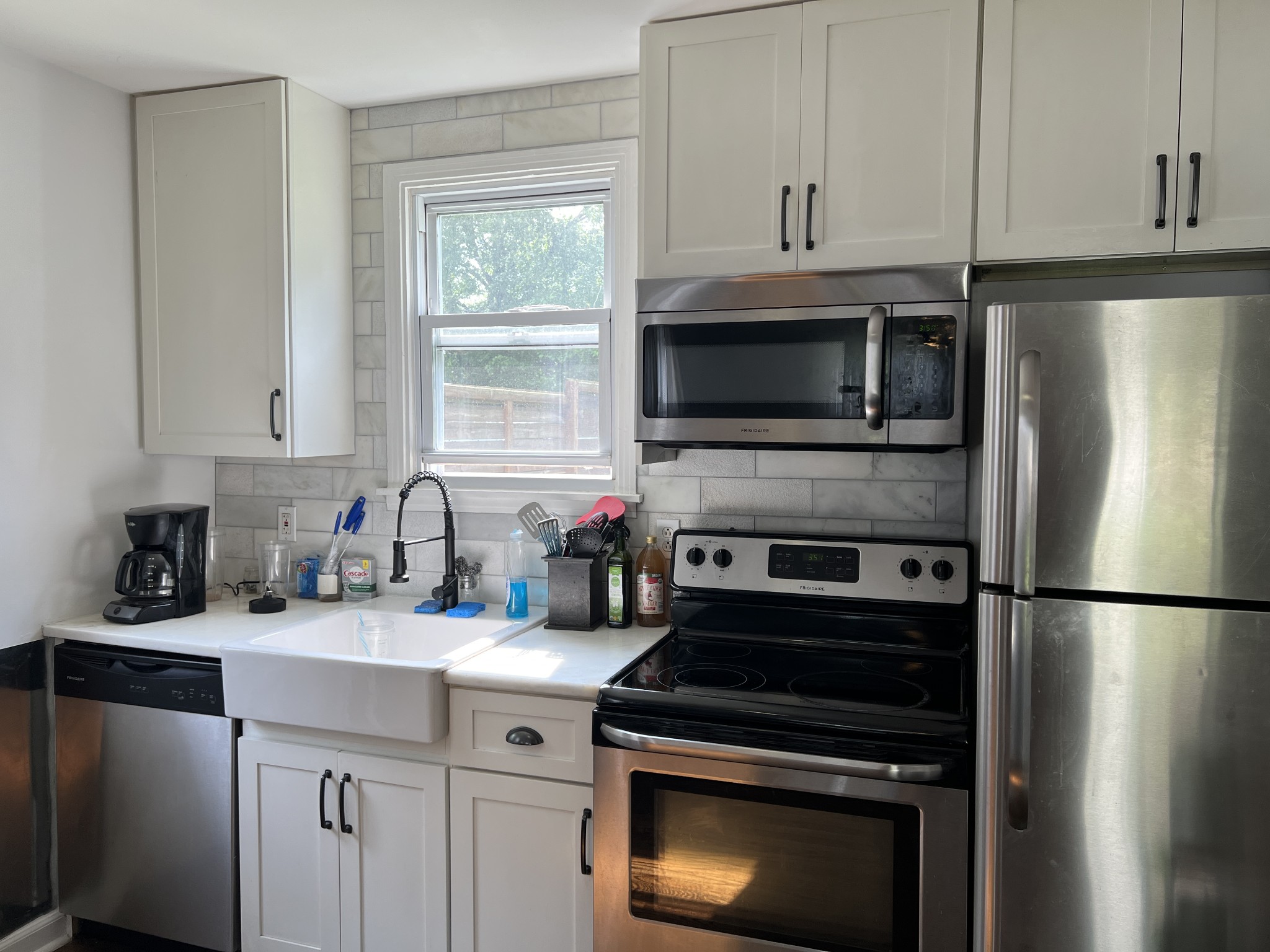 a kitchen with a sink stove and microwave