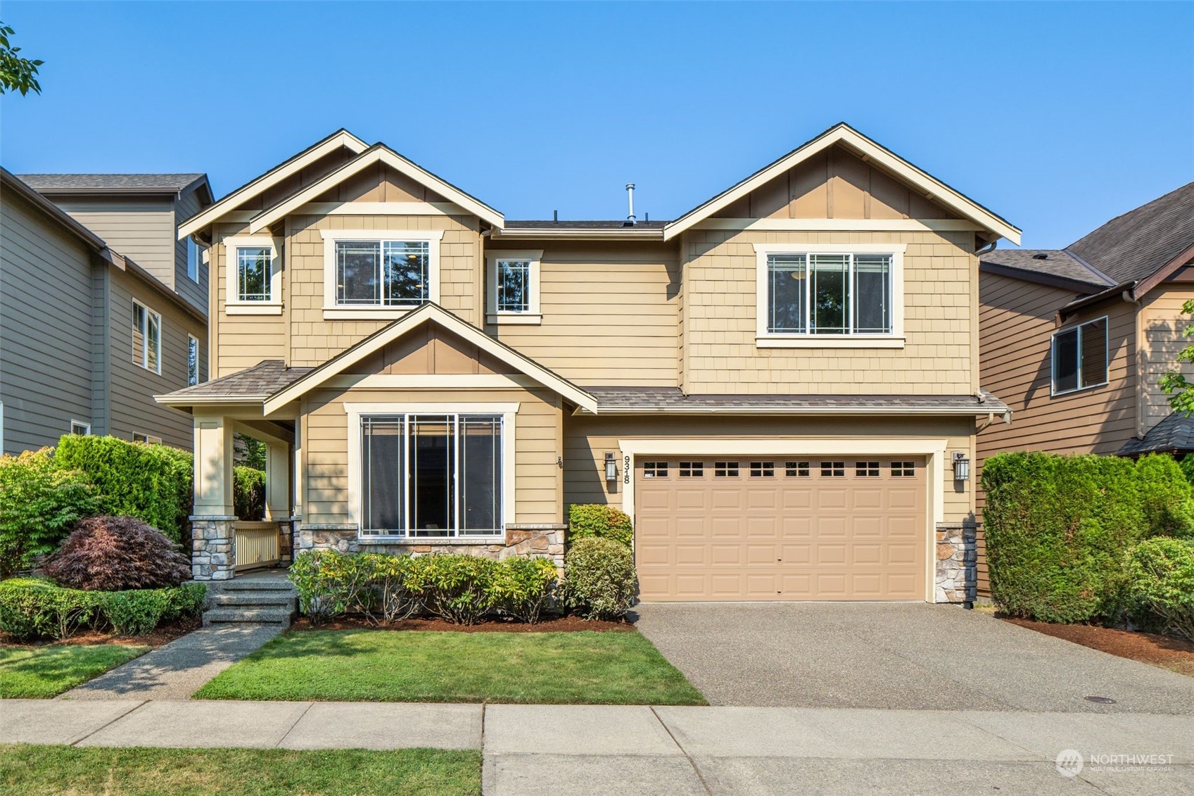 a front view of a house with a yard and garage