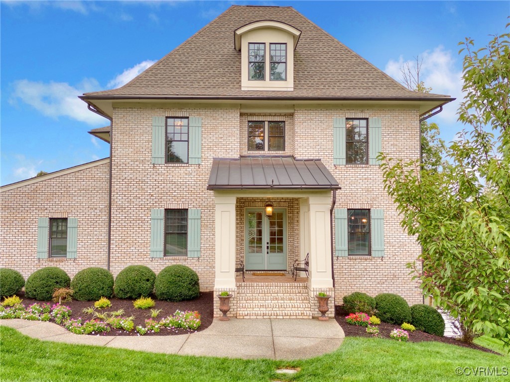 a front view of a house with garden