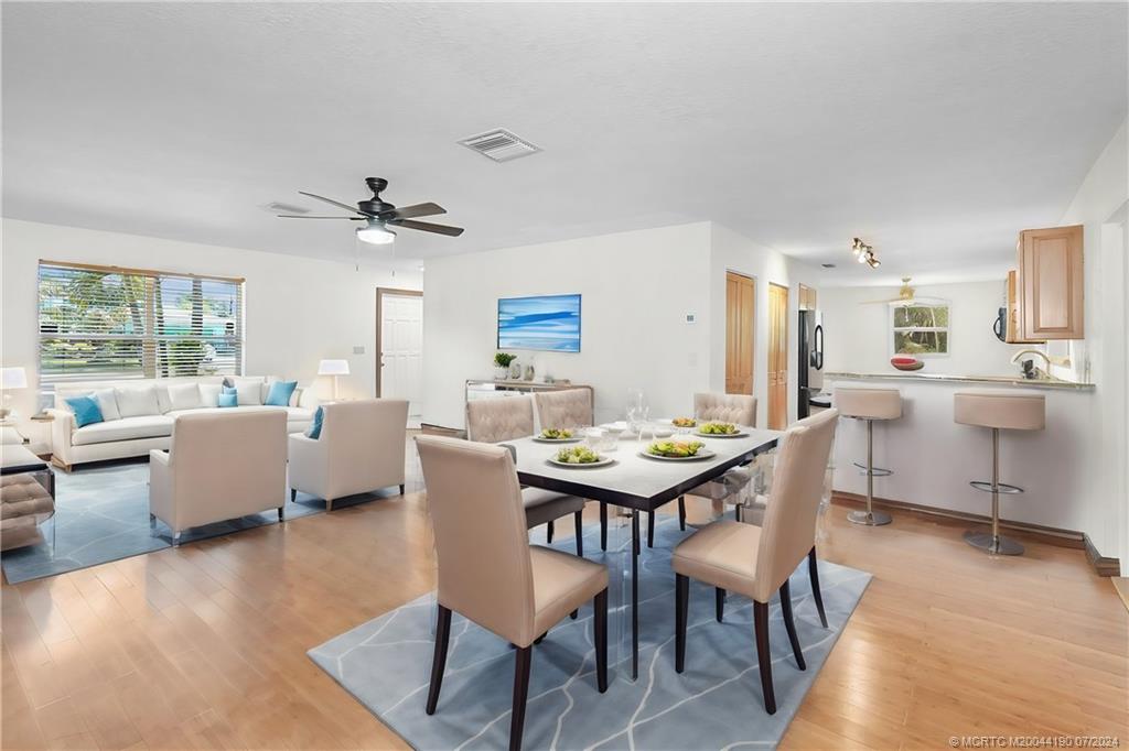 a view of a dining room with furniture and wooden floor