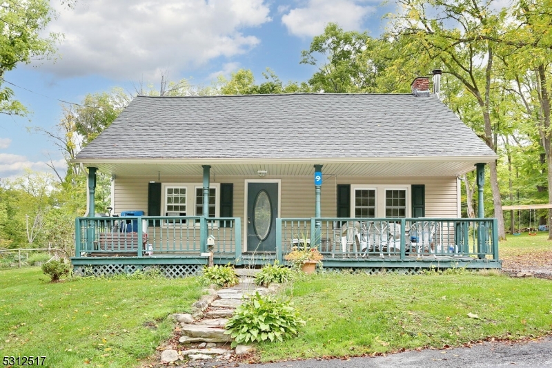 a front view of house with a garden and patio