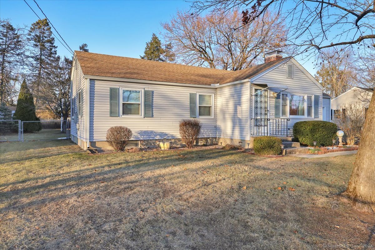 a view of a house with a yard covered in snow