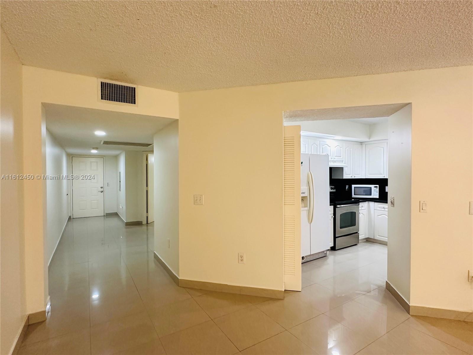 a view of a kitchen from a hallway