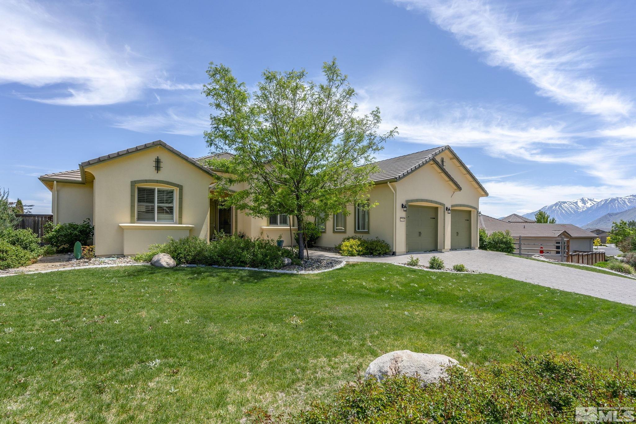 a front view of a house with a yard and garage