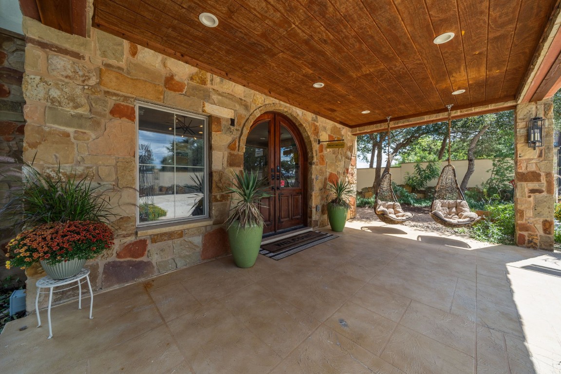 a view of a patio with table and chairs and potted plants