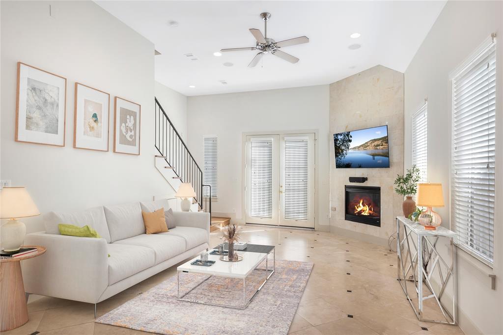 a living room with furniture a fireplace and a flat screen tv