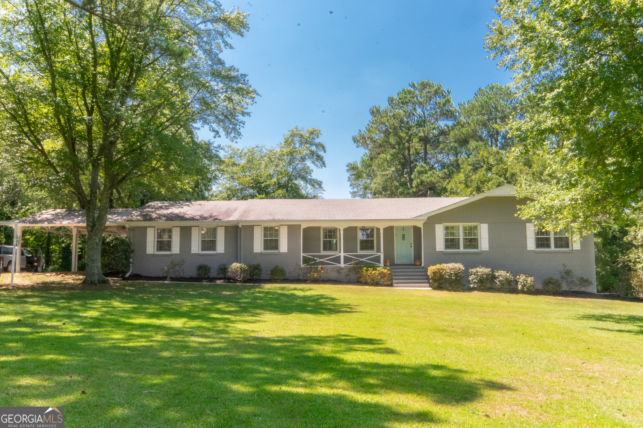 a front view of a house with a garden