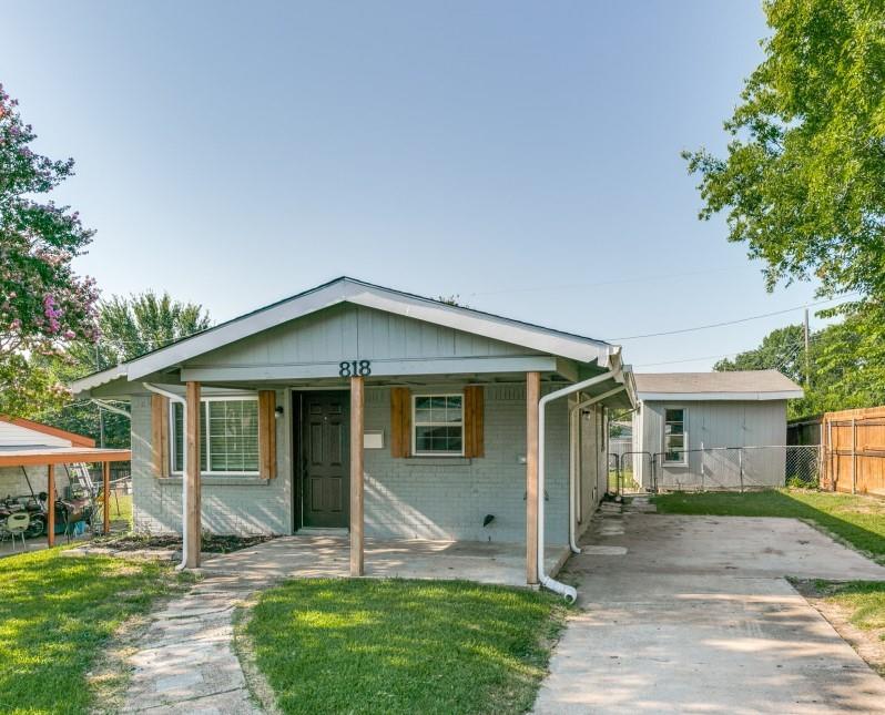 a front view of a house with a yard and porch