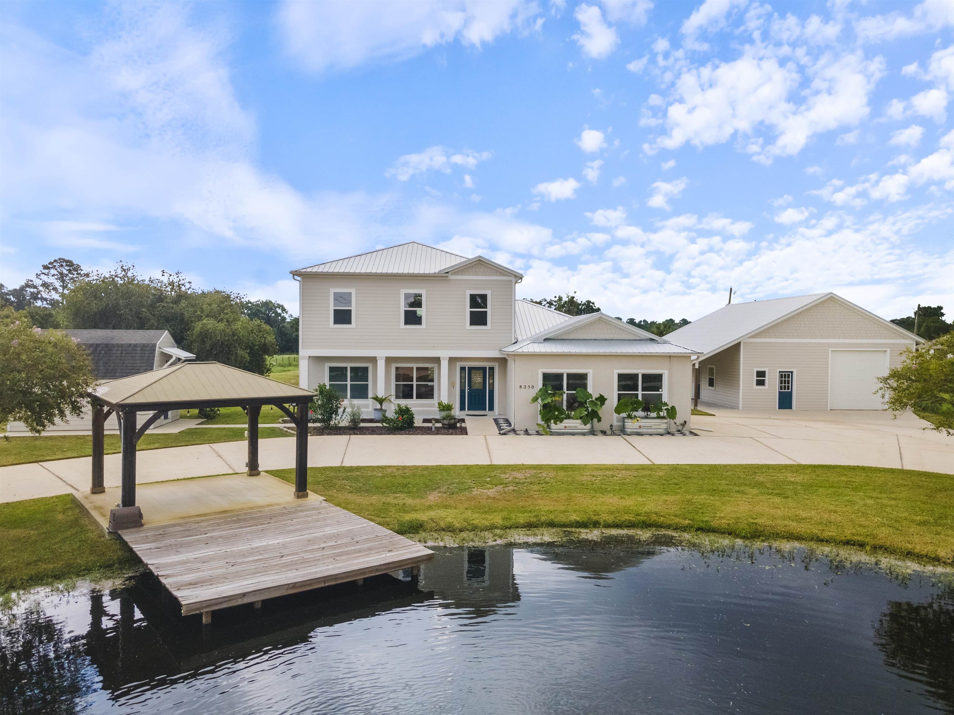 a view of a house with pool and chairs