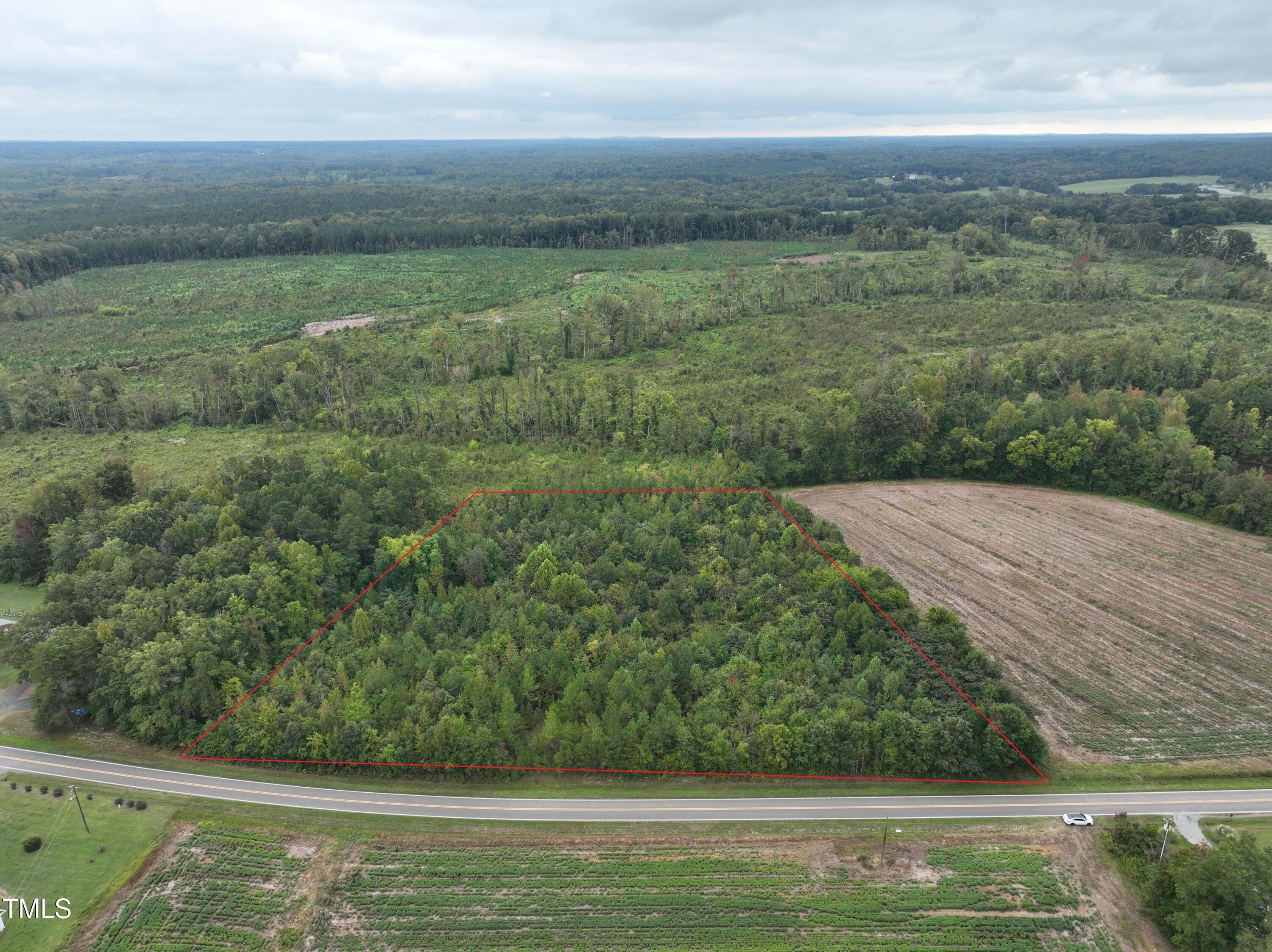 a view of a field with an ocean view