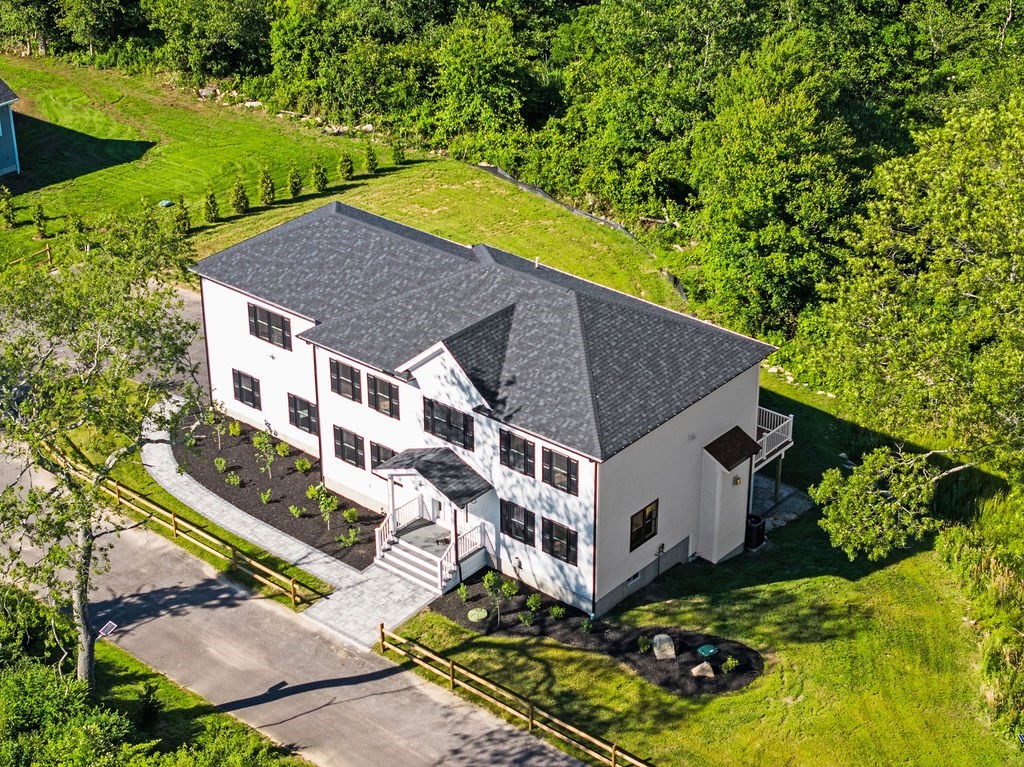 an aerial view of a house with a yard