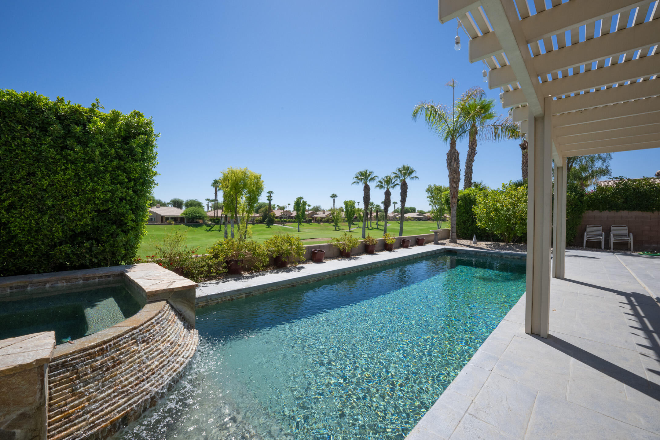 a view of swimming pool from a garden