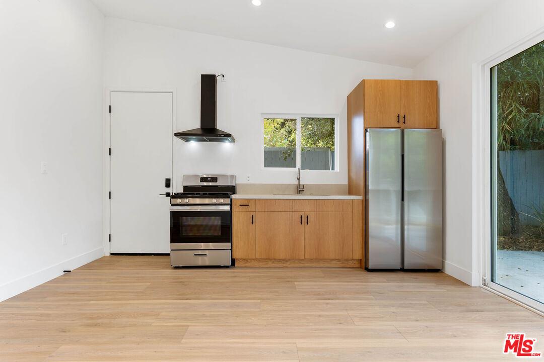 a kitchen with a refrigerator and a stove