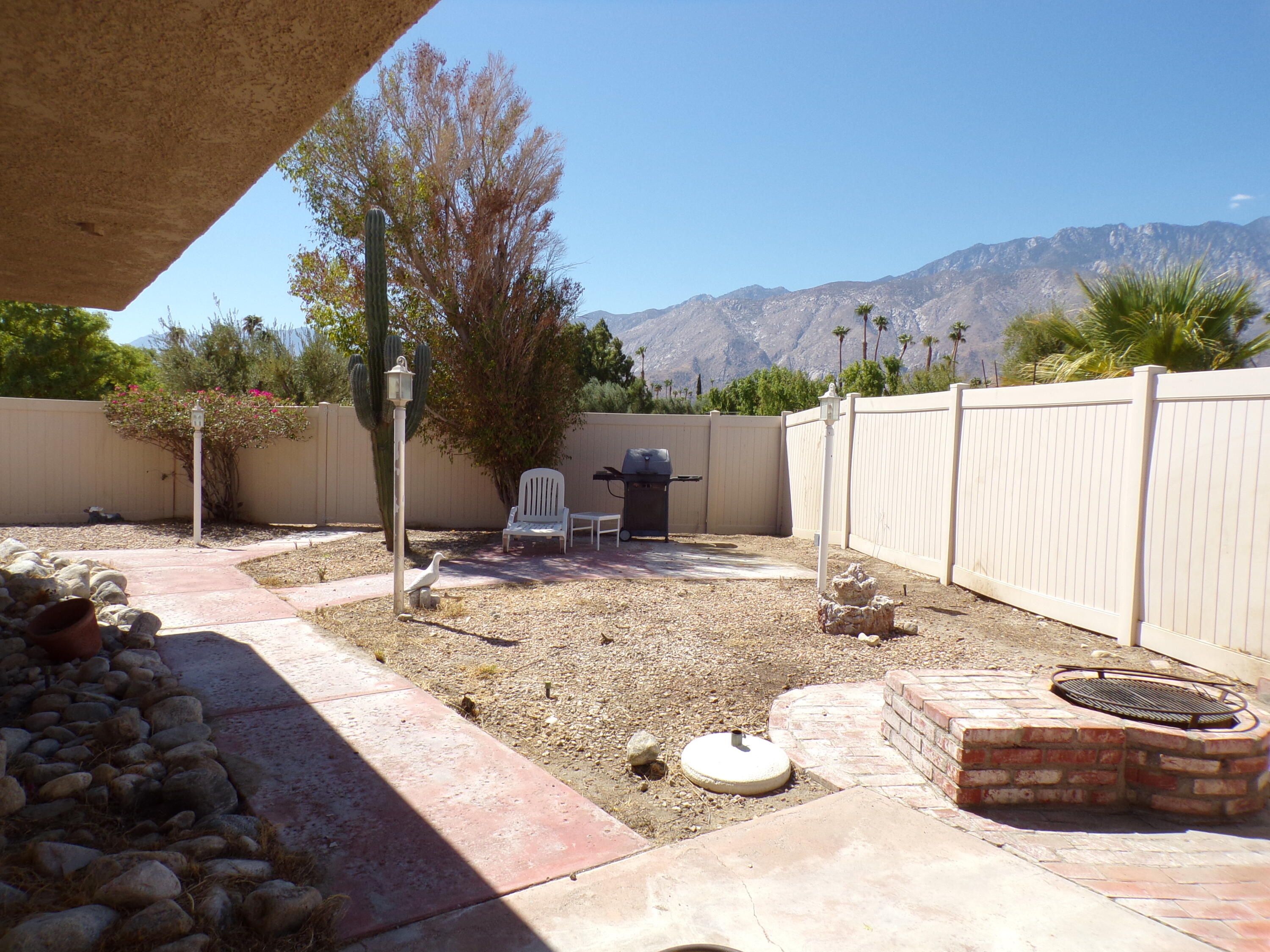 a view of a backyard with table and chairs