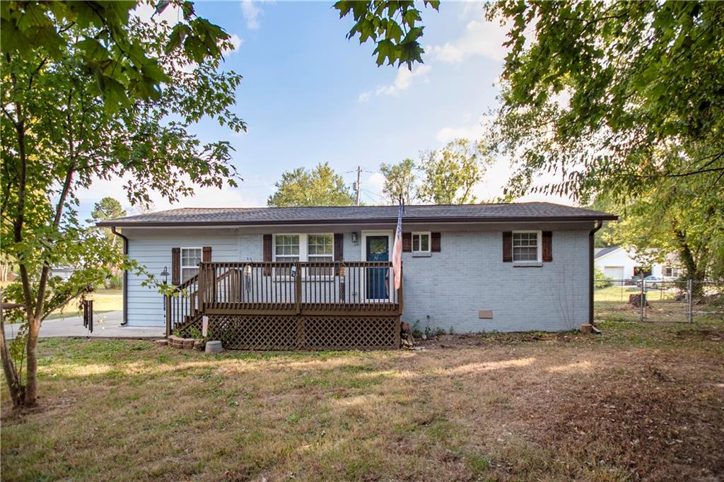 a view of a house with a backyard and a tree