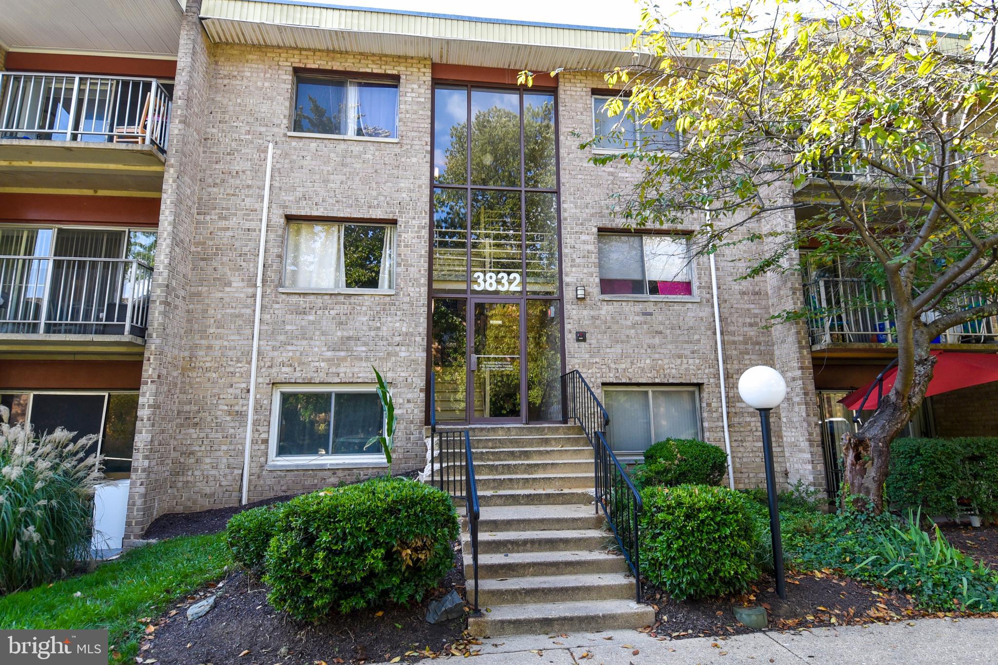 a front view of a house with a garden and plants