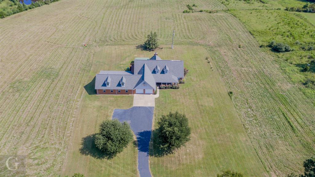 a aerial view of a house with a yard